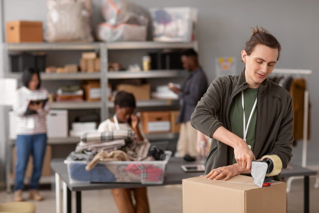 Small business team preparing parcels for bulk shipping
