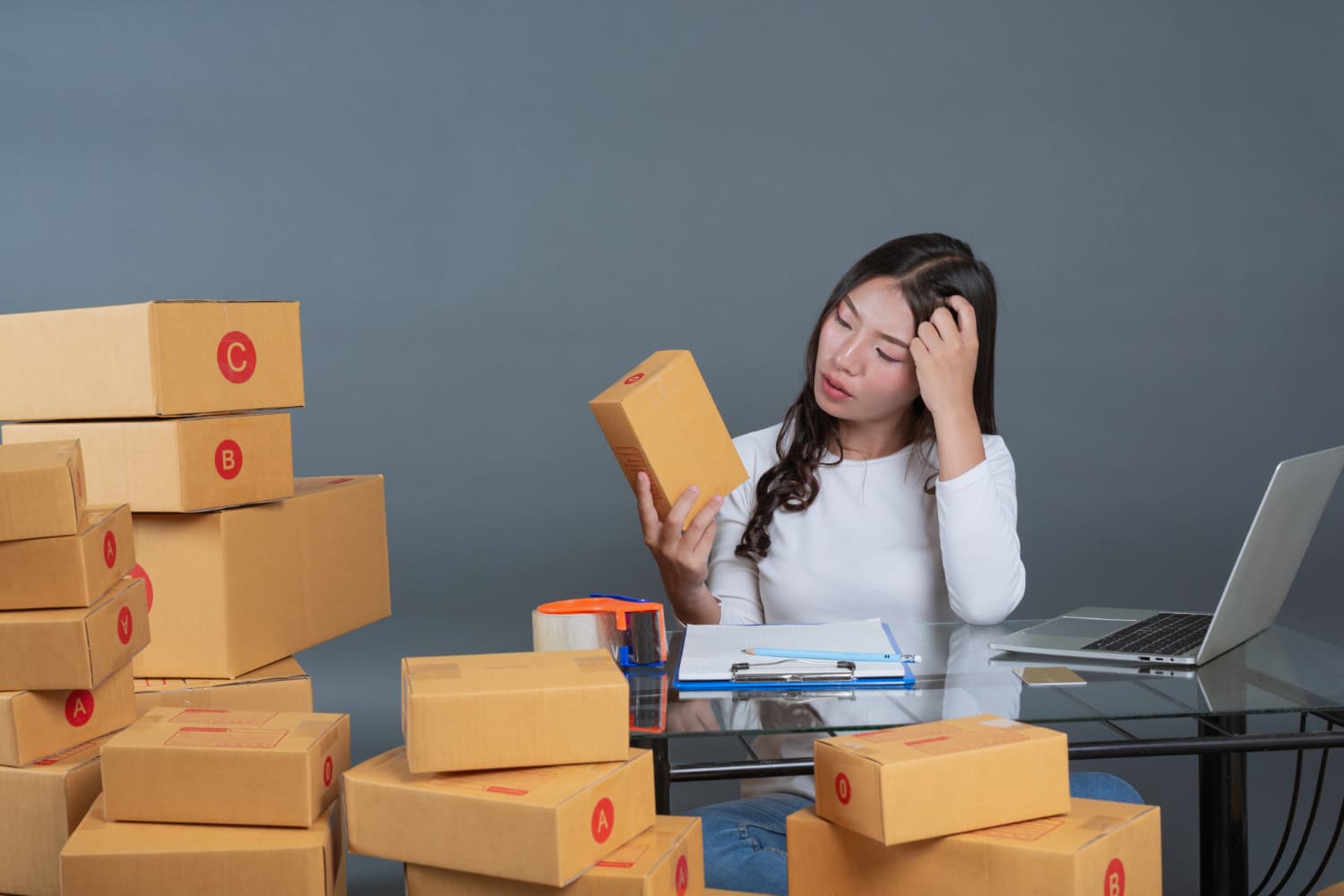 Warehouse worker preparing eCommerce parcels for courier pickup