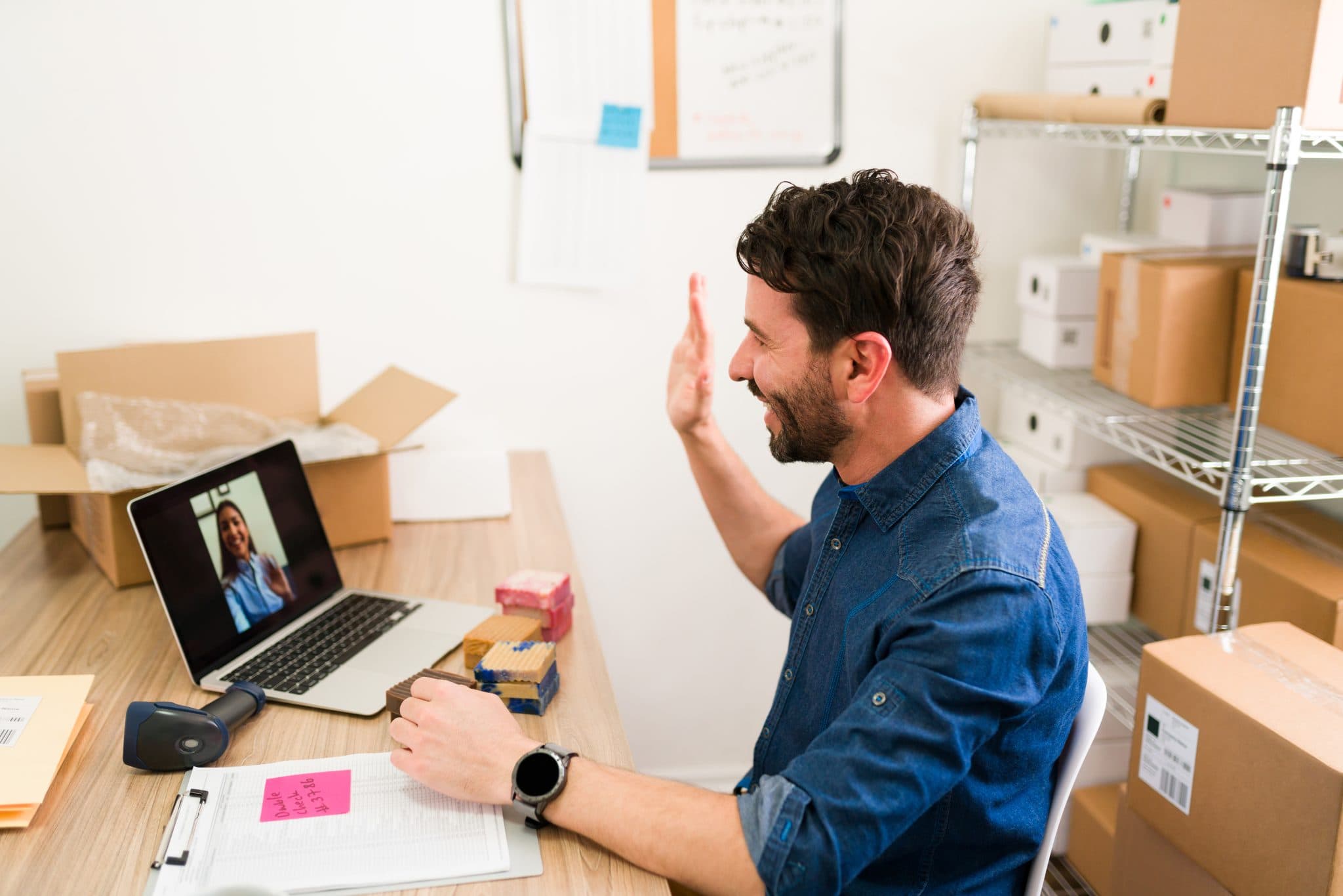 Business owner preparing online orders for courier pickup