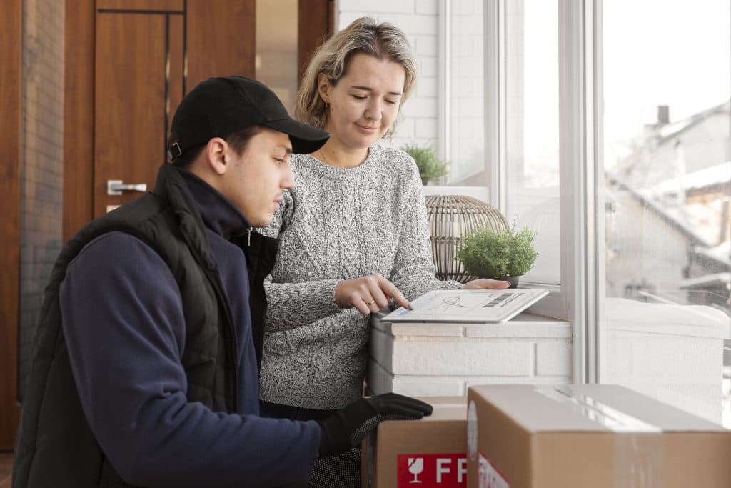 Courier delivering a parcel to a client